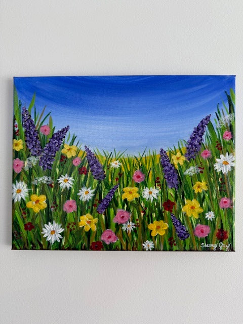 Painting of a field of flowers and a bright blue sky