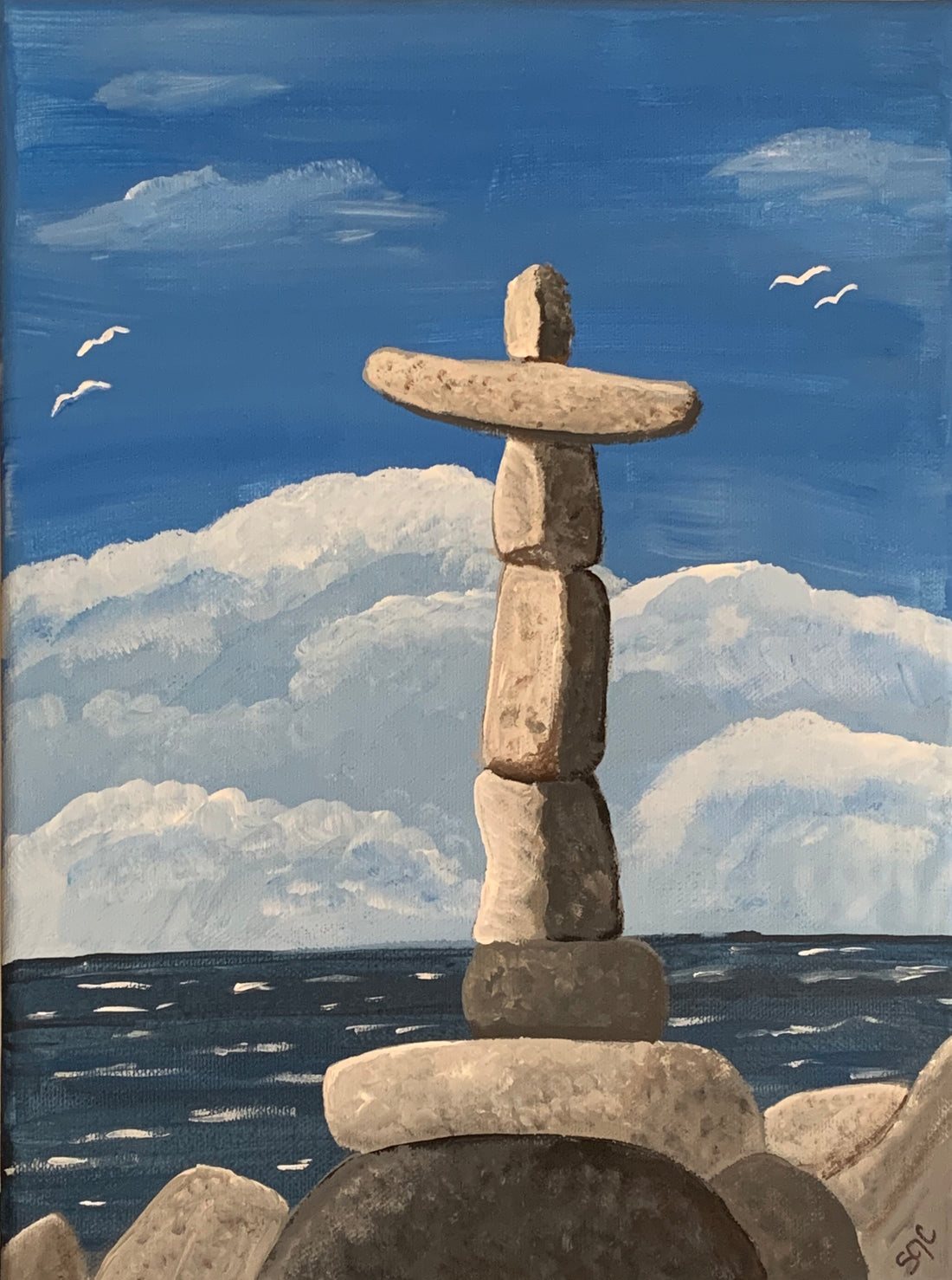 painting of rocks stacked as a cross at the beach